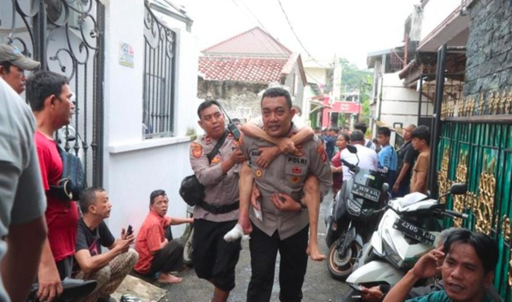 Polisi Gendong Lansia Terjebak Banjir di Cawang